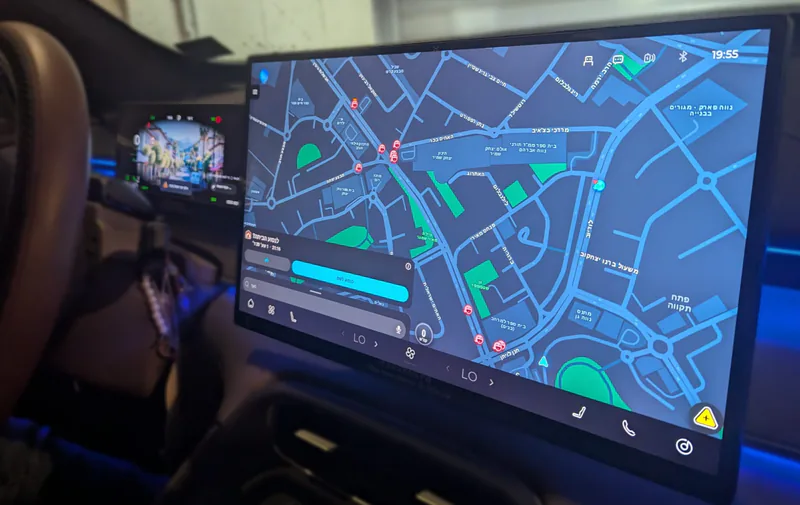 Waze navigation and music apps displayed on a Driver Settings App car screen